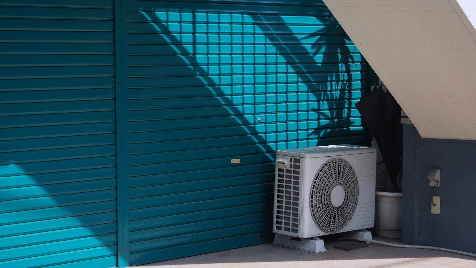 Outdoor air conditioner beside a home
