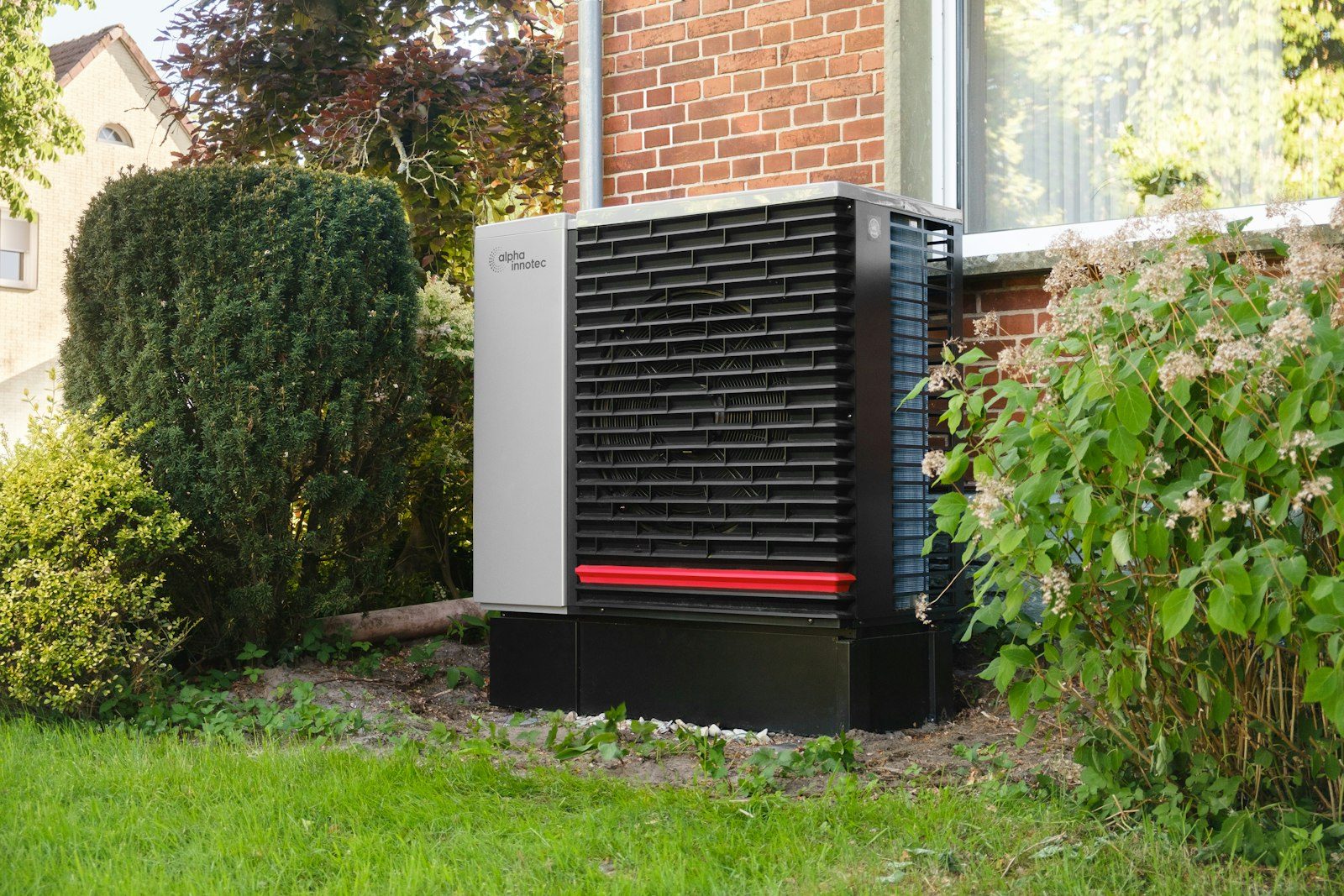 Cold-climate heat pump installed beside a home