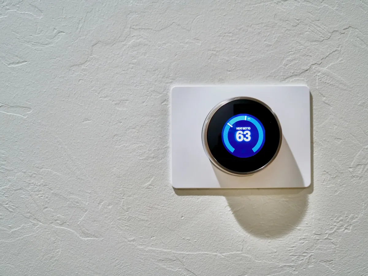 Smart thermostat on a living room wall